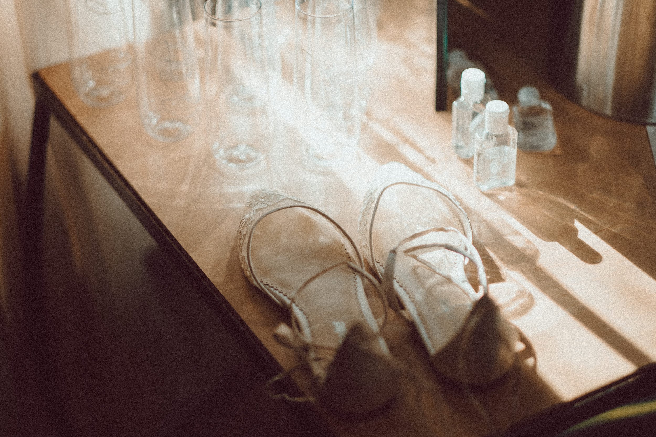 Bridal shoes in sunlight wedding photography