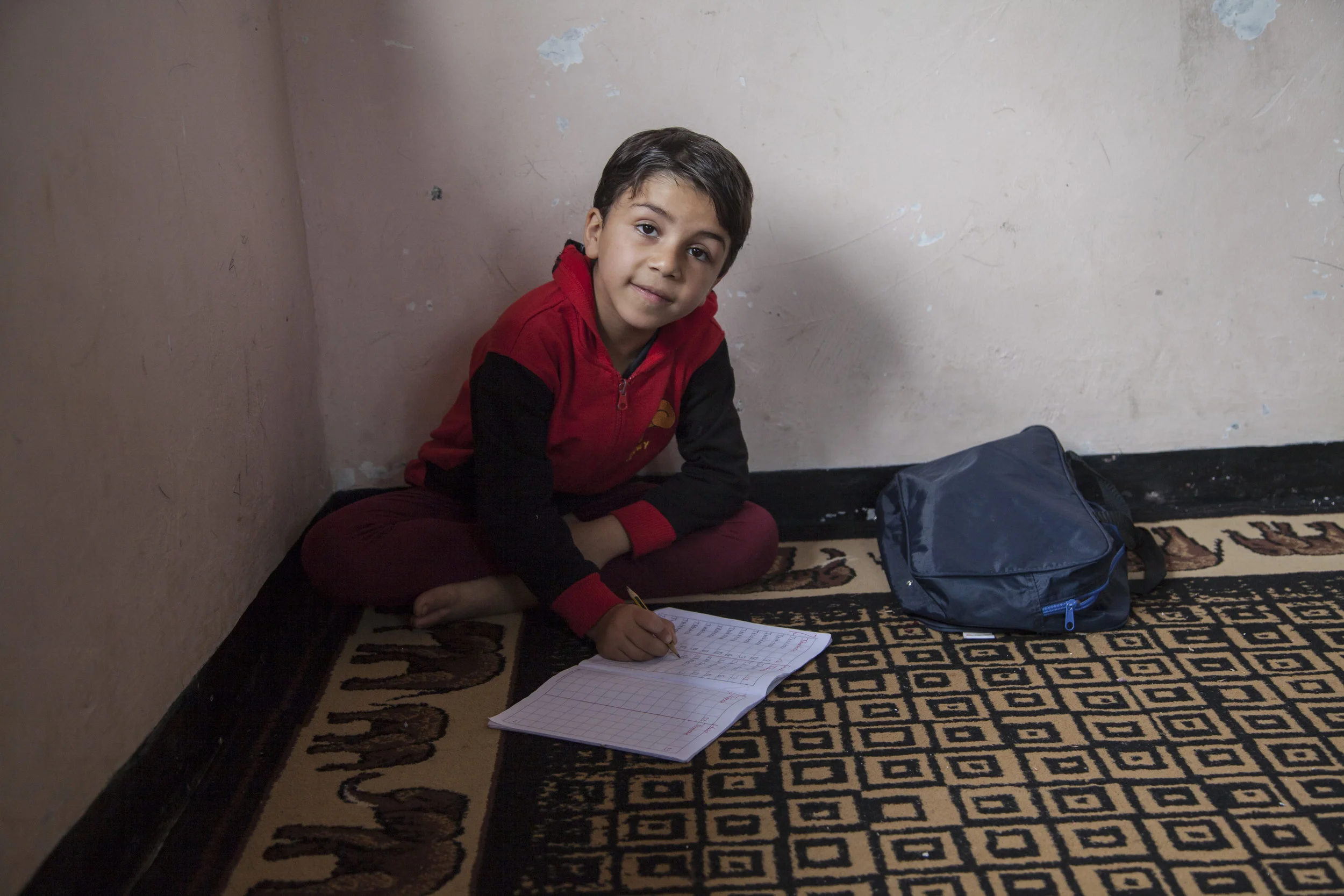 Students in a school run by refugees in Indonesia learn maths, English, art and science