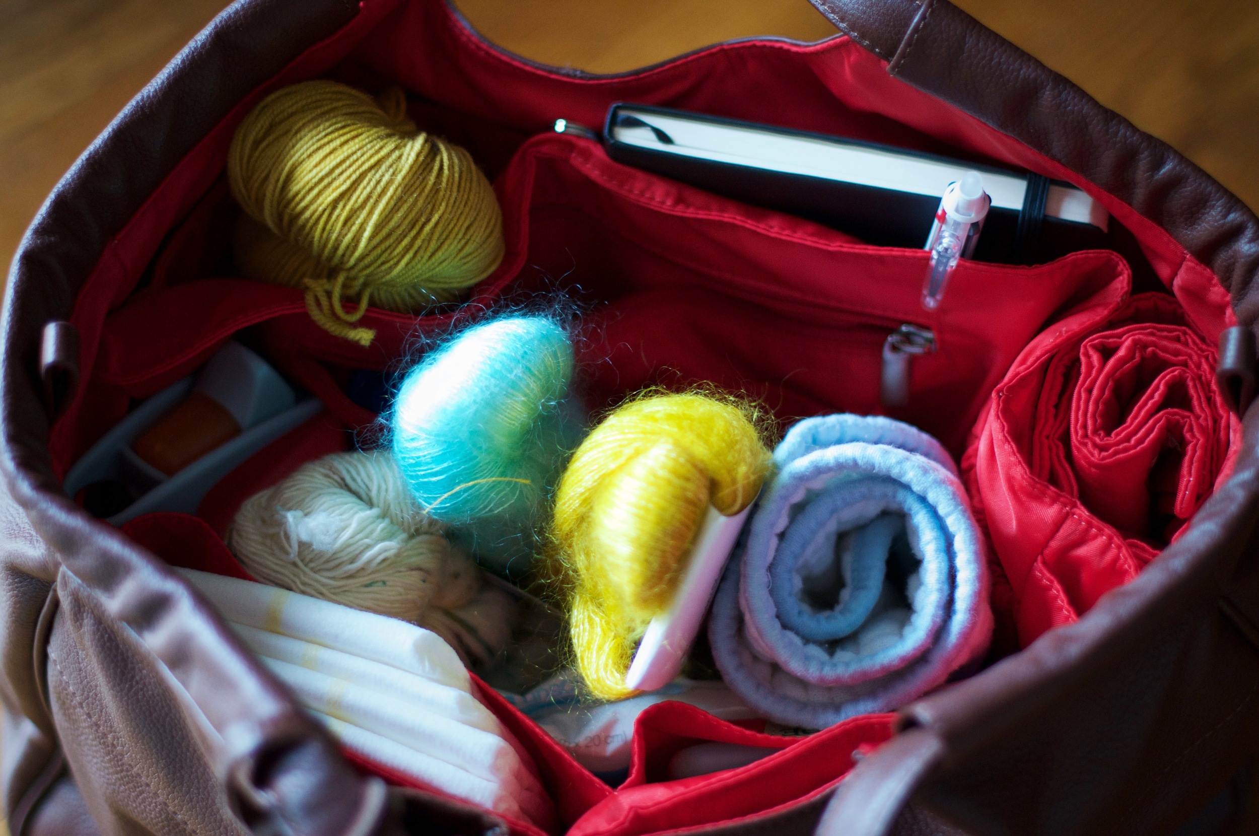 Why yes, that is my yarn and sketchbook snuggled up with diapers, sippy cup and burp cloth - necessities whenever we leave the house!