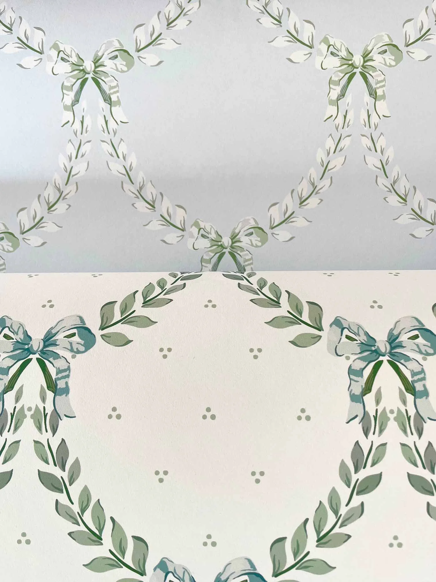 Foliage Festoon wallpaper in China Blue and Trefoil Green & Blue by Isla Simpson, shown side by side to display both colourways.