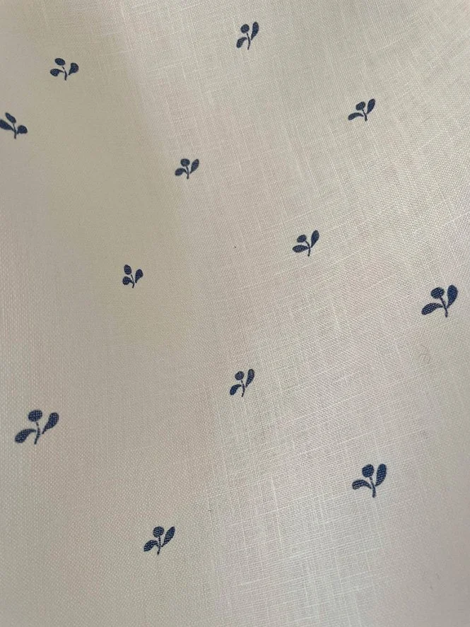 Detail of Lawn Flower ironstone blue swatch highlighting fine flower motifs on midweight linen.