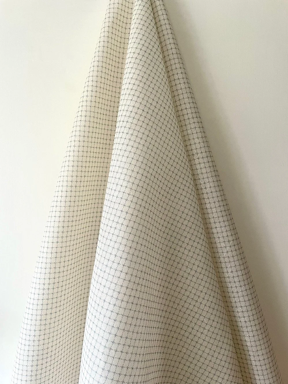 Summer Trellis Pale Blue midweight linen draped to show overall small-scale star trellis pattern.