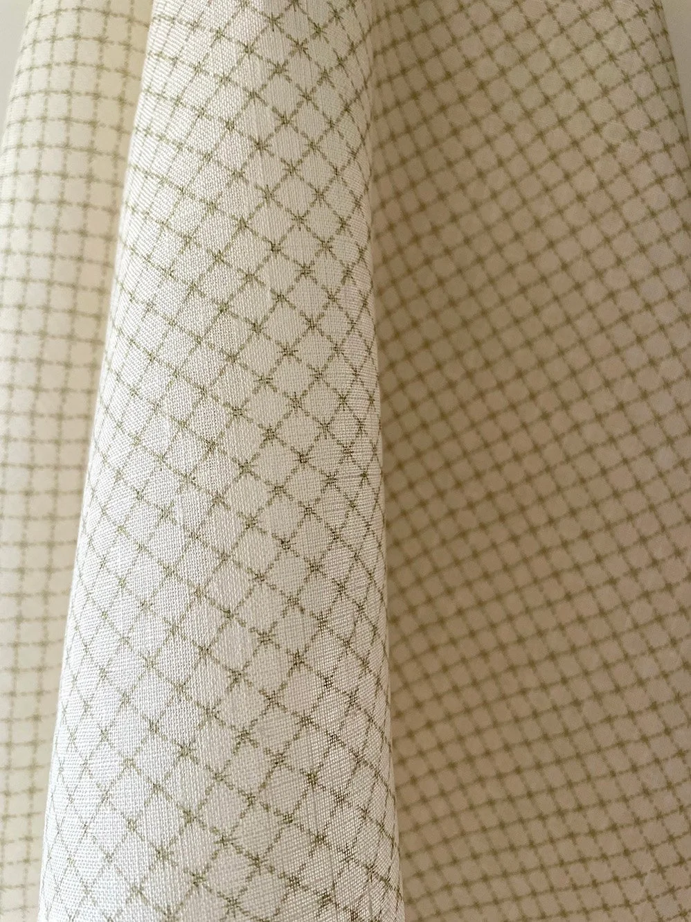 Draped Summer Trellis Eau de Nile Green midweight linen highlighting the soft trellis pattern and fabric fall.