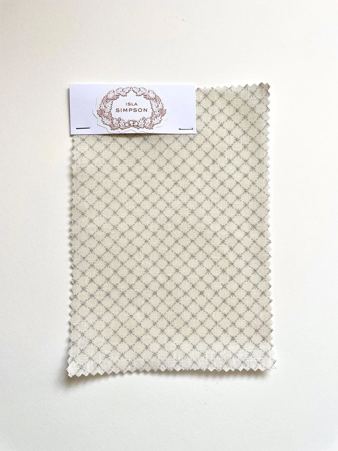 Summer Trellis midweight linen A4 sample showing finely scaled star trellis pattern in pale blue