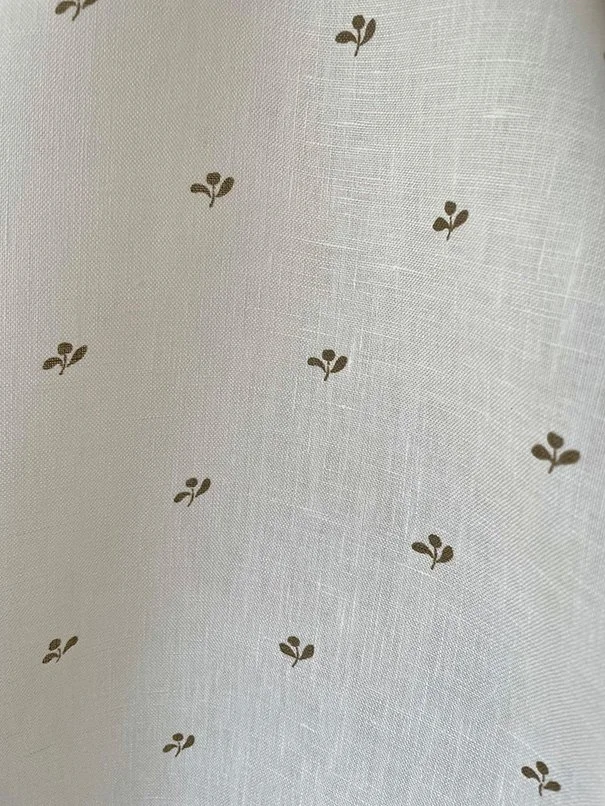 Lawn Flower khaki green close-up, focusing on repeat pattern and midweight linen surface.