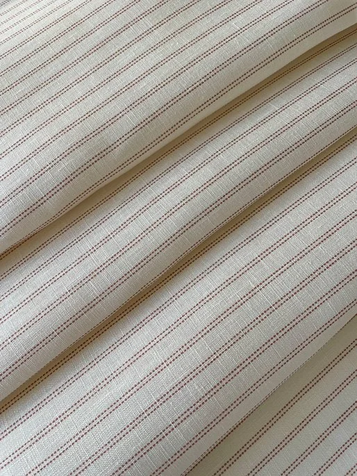 Folded view of marsala pink Pillow stripe design demonstrating scale and fluidity.