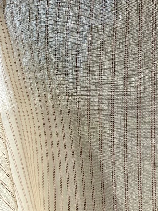 Sheer Pillow stripe fabric in marsala pink shown against window light, demonstrating semi-translucent weave.