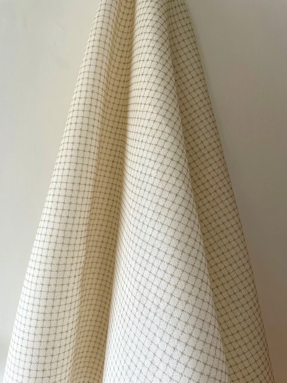 Summer Trellis Eau de Nile Green midweight linen draped to show overall small-scale star trellis pattern.