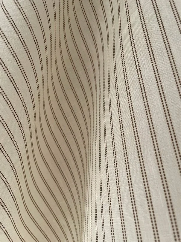 Pillow Stripe fabric in saddle brown draped naturally to show the soft fall and texture.