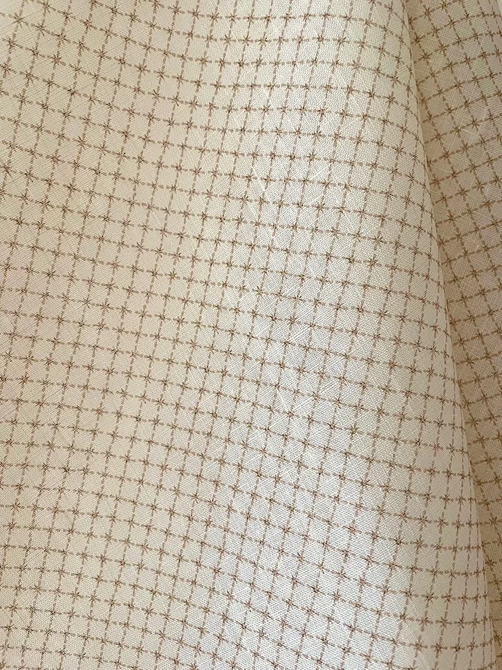 Close-up of Summer Trellis Plaster Pink midweight linen showing small star trellis pattern and texture.