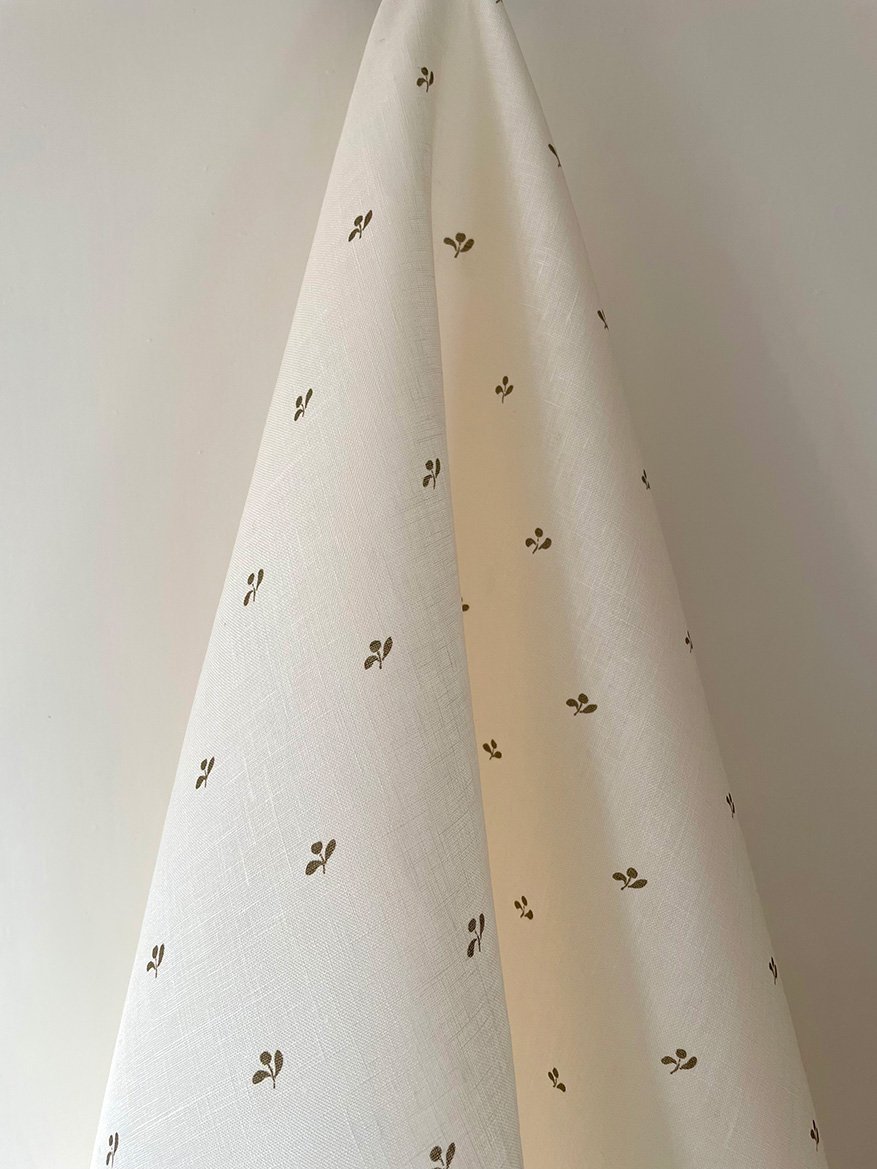 Lawn Flower khaki green fabric length draped to highlight pattern scale and flow.