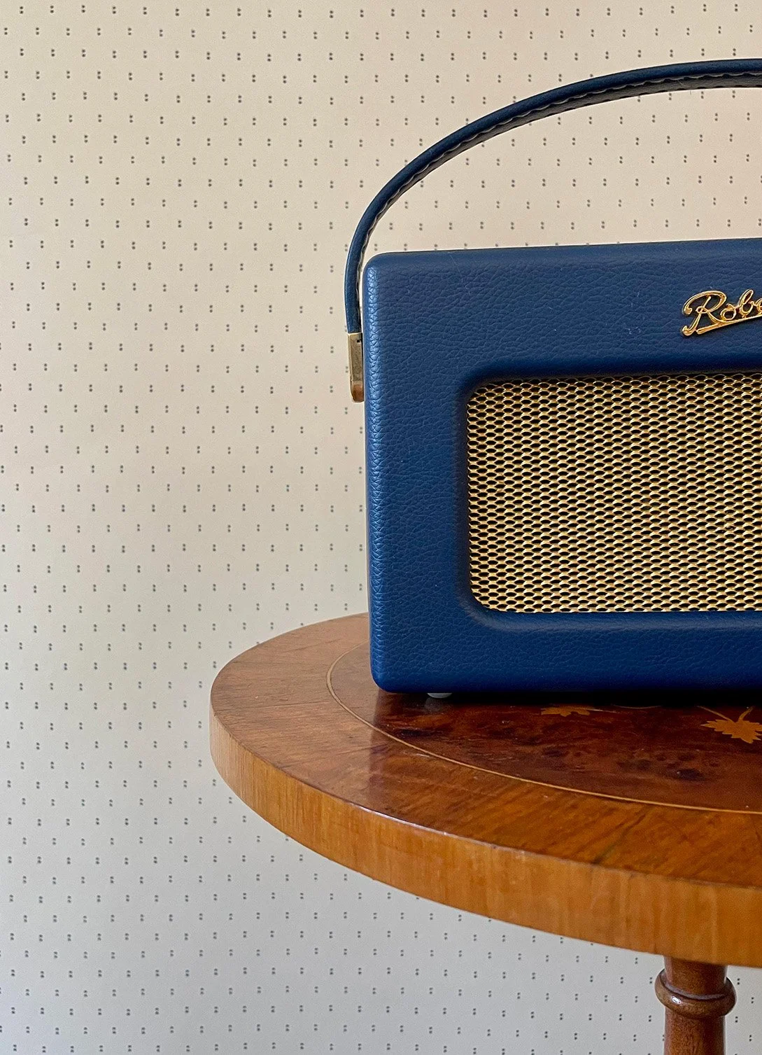 Pair of Dots Ironstone Blue on cream wallpaper with blue radio on round wooden table