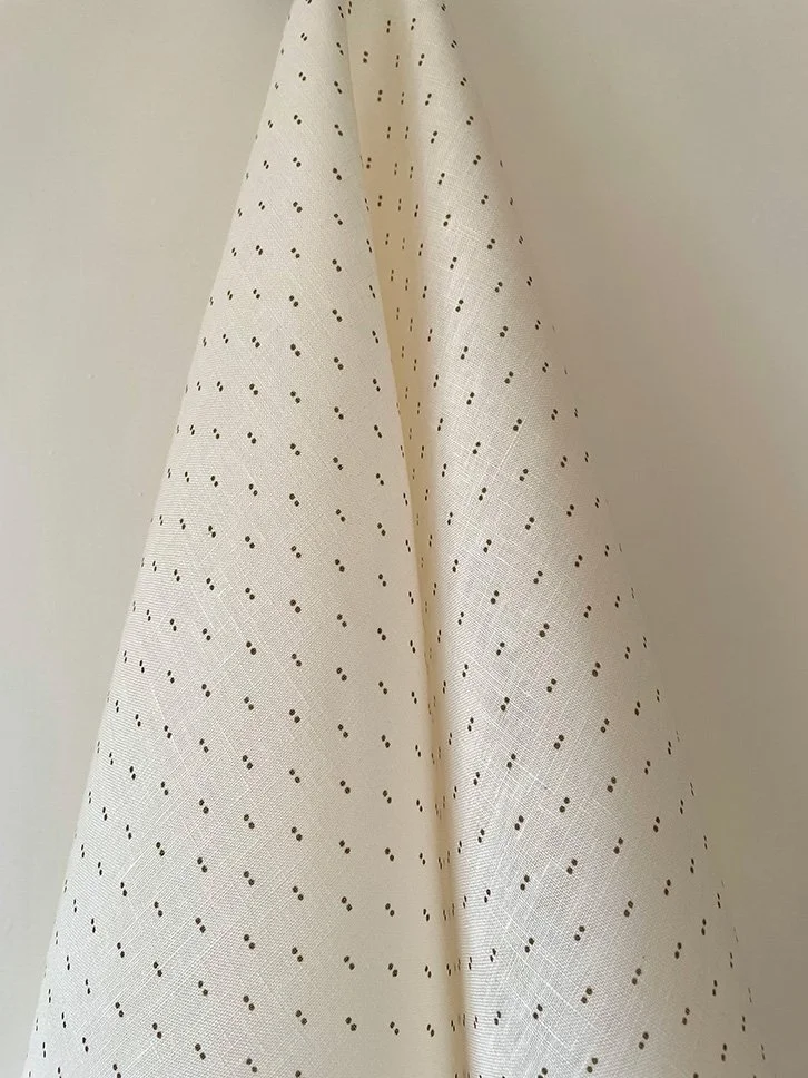 Khaki on cream Petite Pair of Dots fabric hanging in gentle folds, revealing small-scale spot design.
