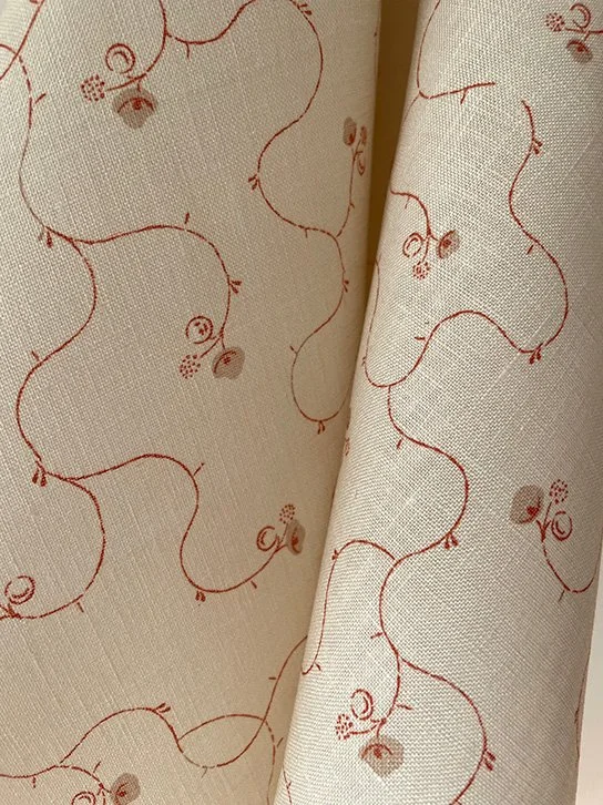 Russet and eggshell Parlour Posy linen with delicate folds highlighting the lightweight, semi-opaque quality and hand-drawn floral design.