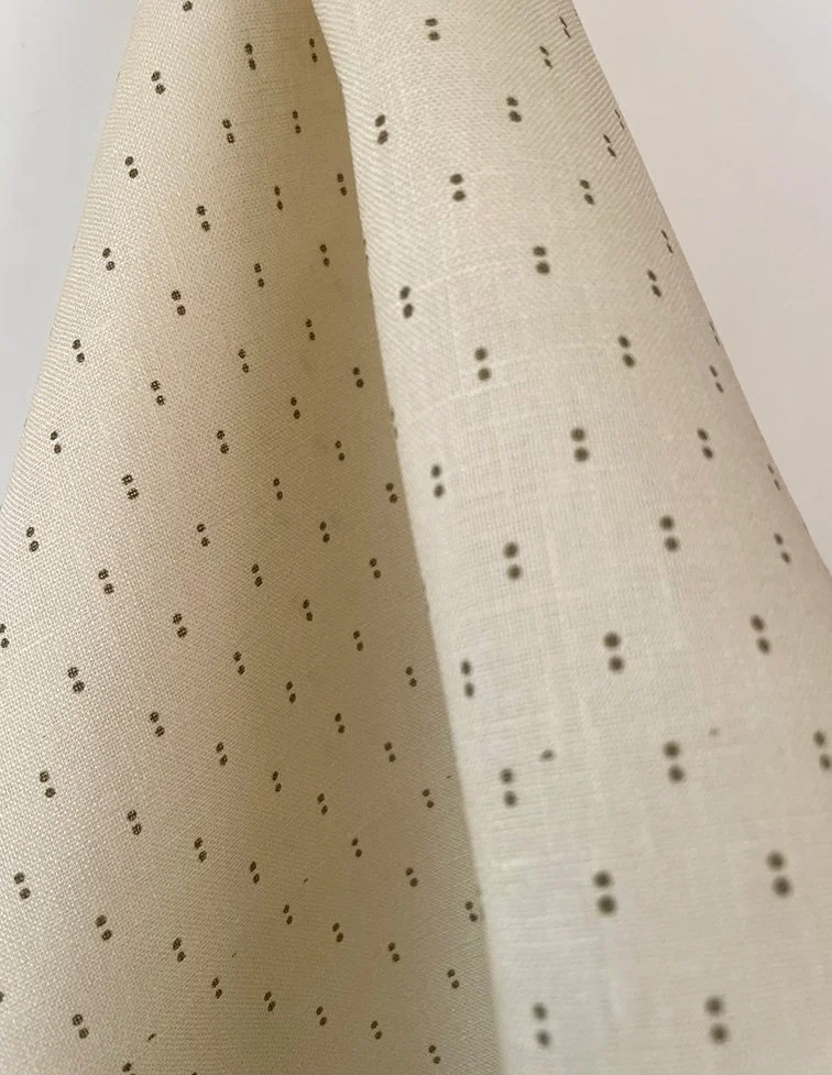 Khaki on butter yellow Petite Pair of Dots fabric length in relaxed folds, showing playful dot repeat.