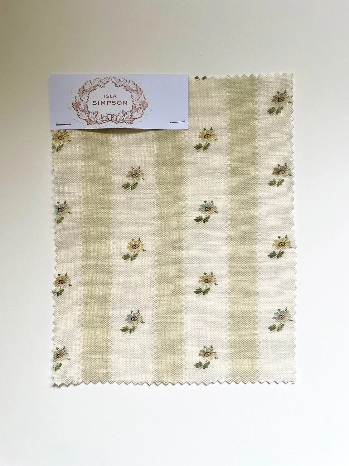 Hat Box Stripe midweight linen sample in Eau de Nile Green with candy stripes and small daisy sprigs.