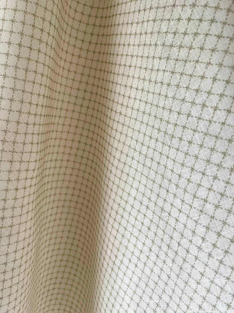 Close-up of Summer Trellis Eau de Nile Green midweight linen showing small star trellis pattern and texture.