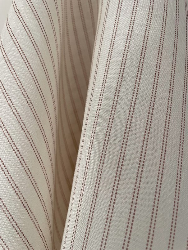 Weave close-up illustrating structure and fiber quality of the Pillow stripe pattern in marsala pink.