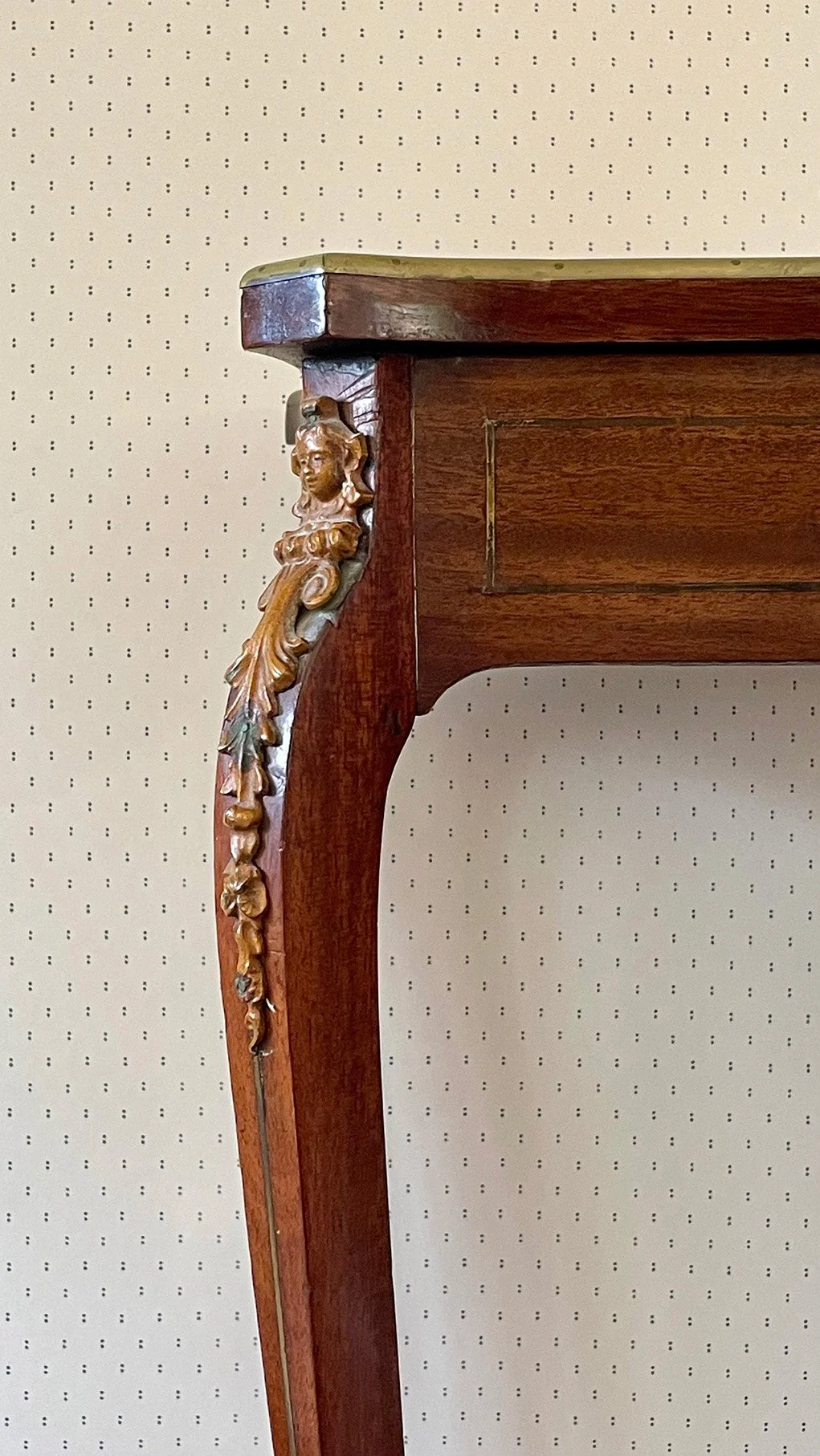 Pair of Dots Ironstone Blue on cream wallpaper behind carved wooden side table