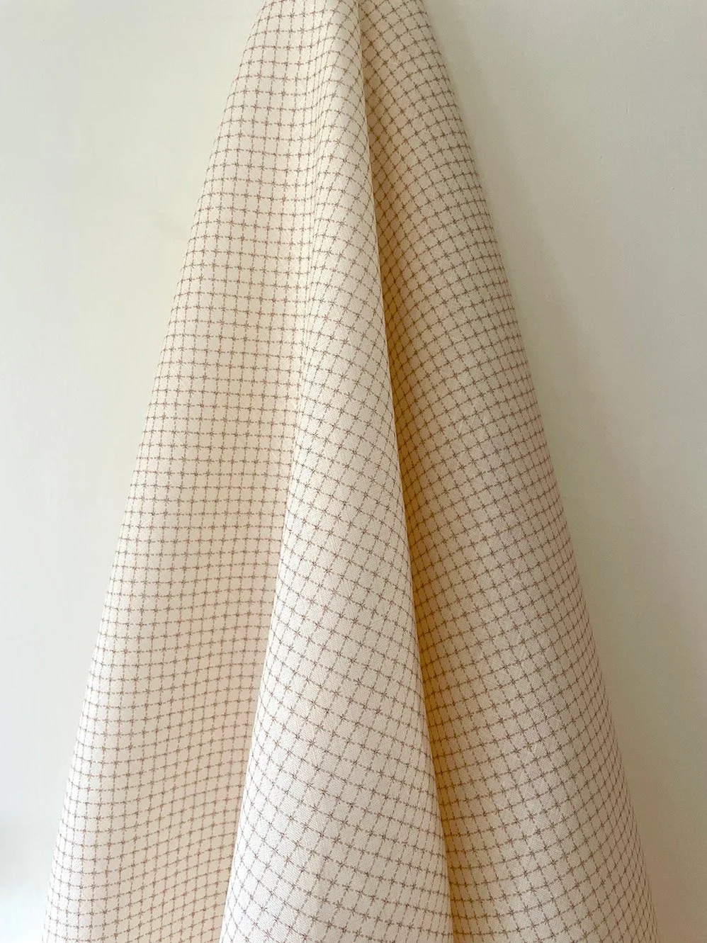 Summer Trellis Plaster Pink midweight linen hanging to show overall small-scale star trellis pattern.