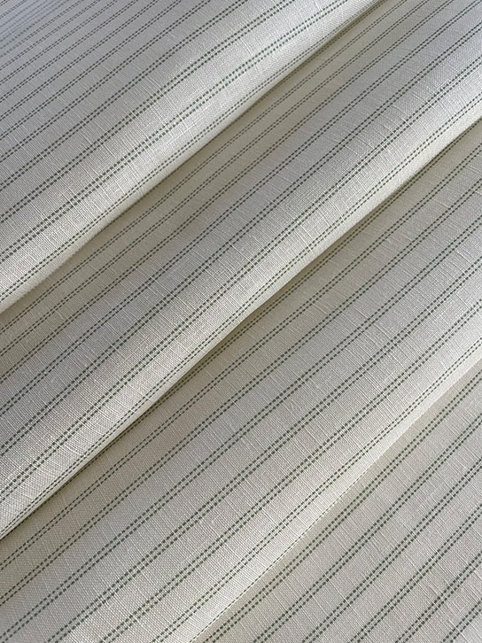 Folded view of Pillow stripe design in Lichen Green demonstrating scale and fluidity.