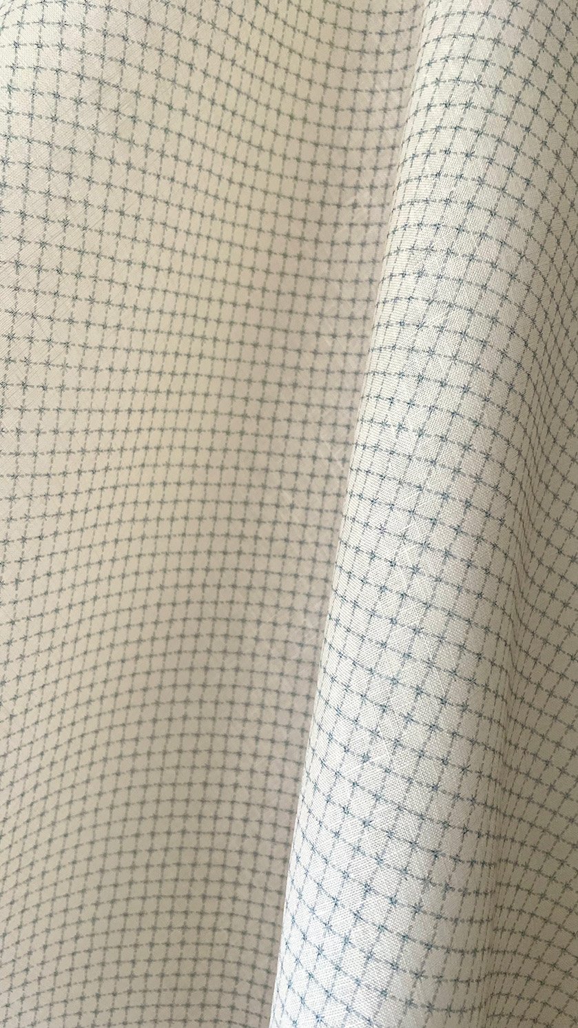 Close-up of Summer Trellis Eau de Nile Green midweight linen showing small star trellis pattern and texture.