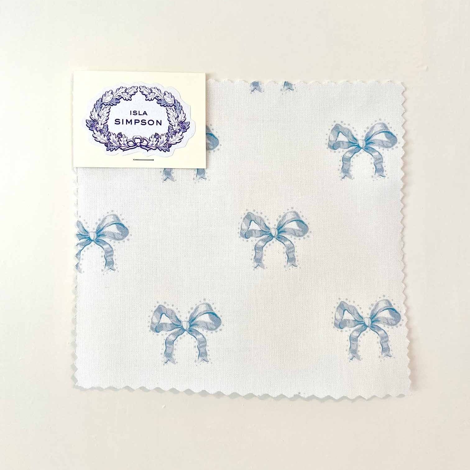blue bow cotton fabric sample of Lucy's silk ribbon by Isla Simpson