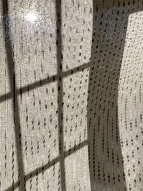 Cornflower Blue Pillow Stripe fabric with leaded window shadow pattern cast across the surface.