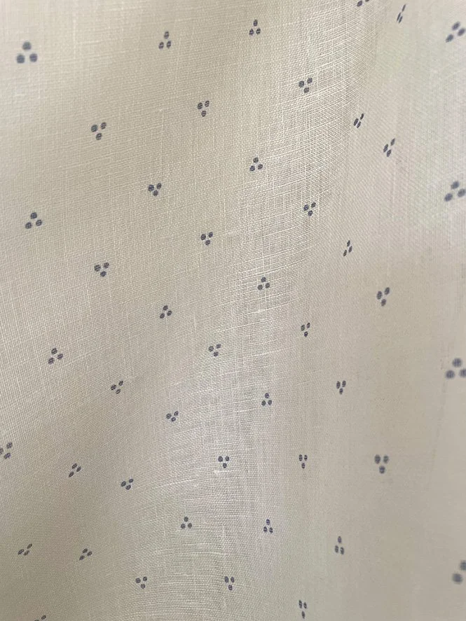 A detailed view of Petite Dot Trio fabric in faded blue showing texture of midweight linen.