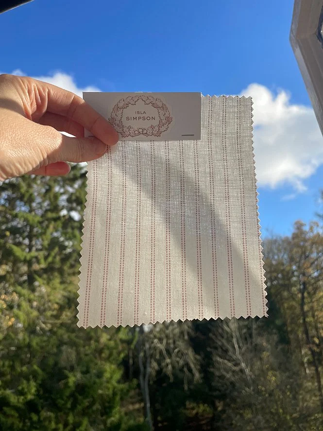 Pillow Stripe fabric swatch backlit to show opacity and light filtering through weave