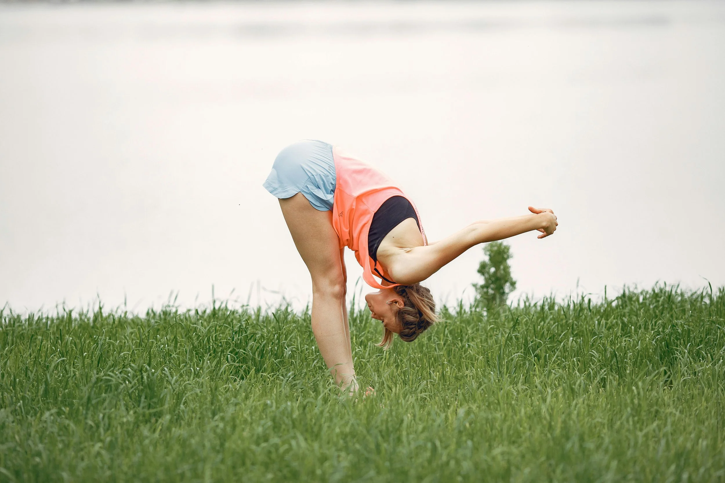 An active woman stretching outdoors as part of her fitness and recovery routine
