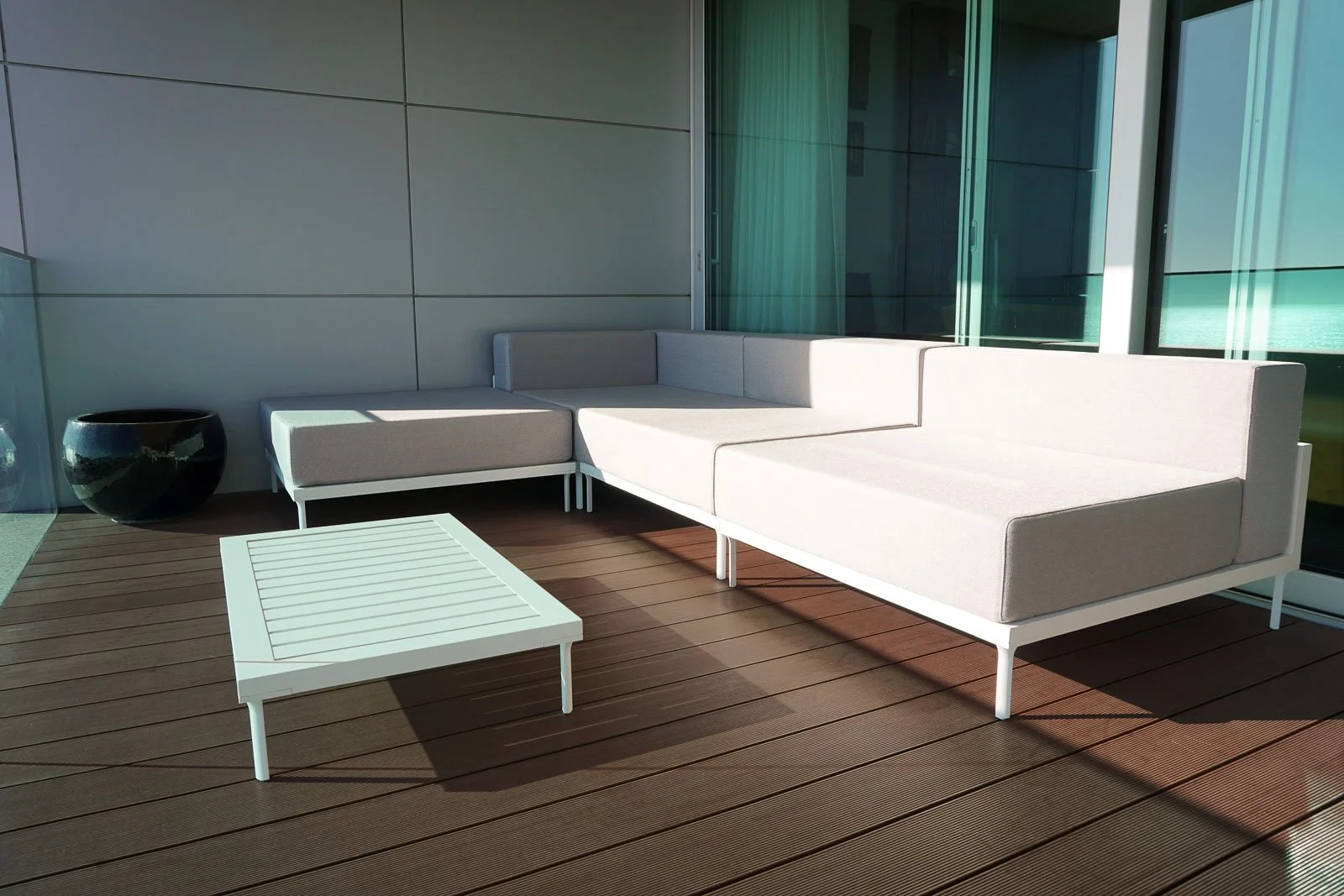 Seaside balcony with outdoor sofa and lounge furniture