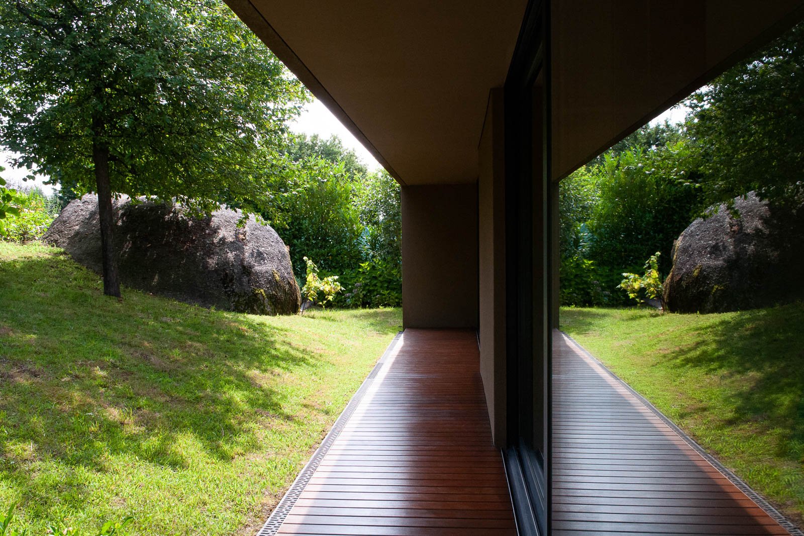 Architectural detail of living room side deck with garden view windows