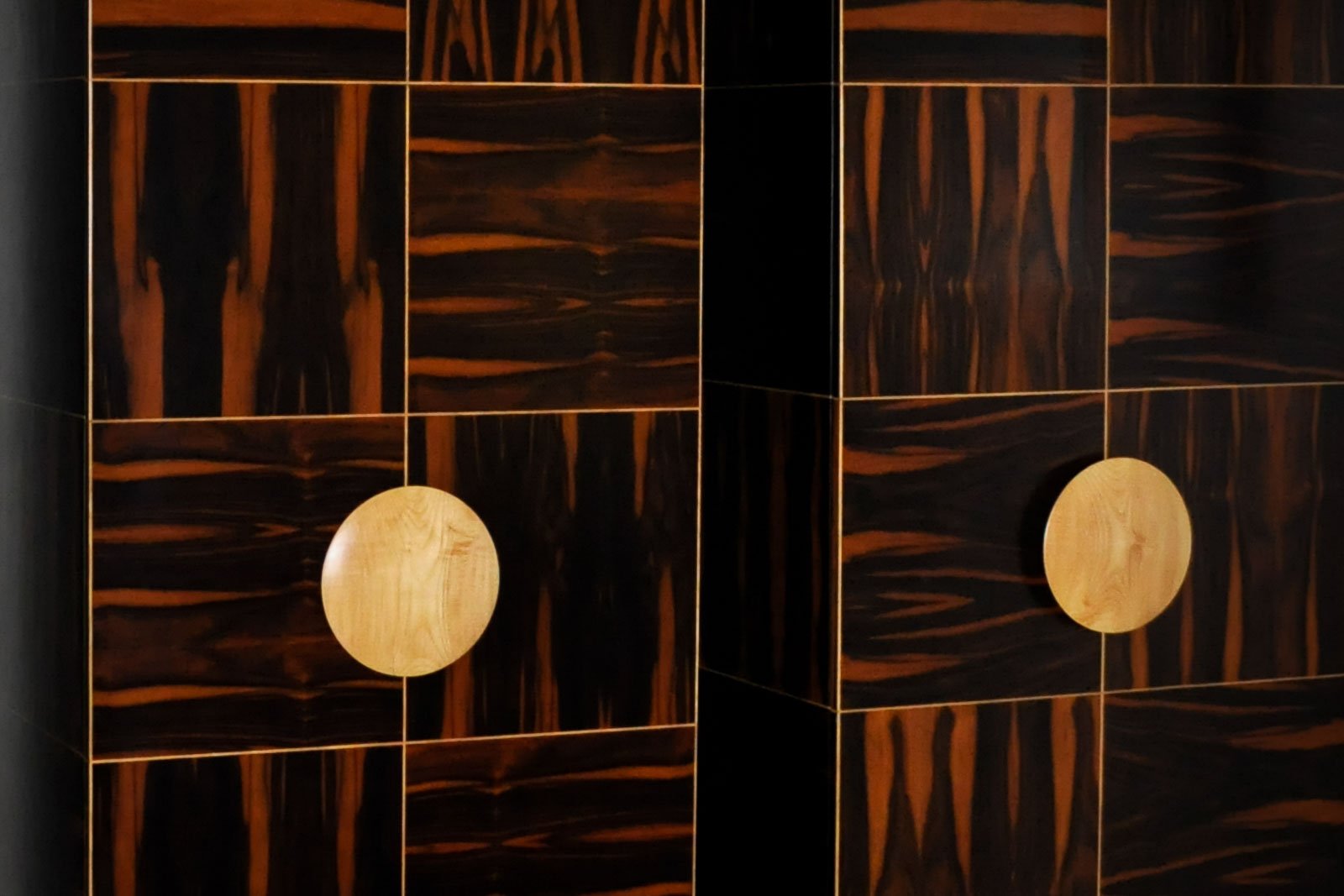 Detail of modern ebony inlay marquetry cabinets with circular satinwood handles