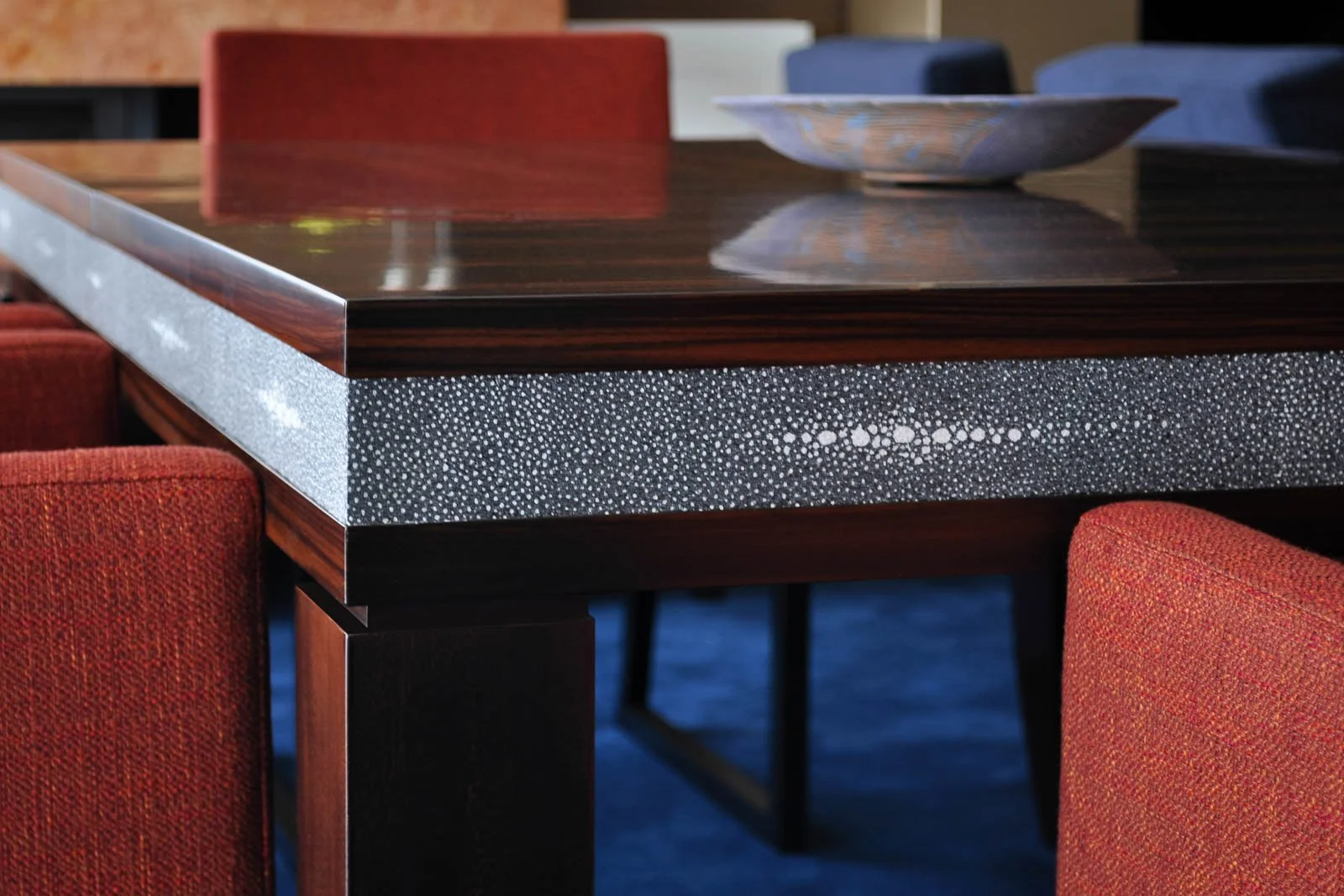 Detail of a Macassar ebony dining table with galuchat panel accents