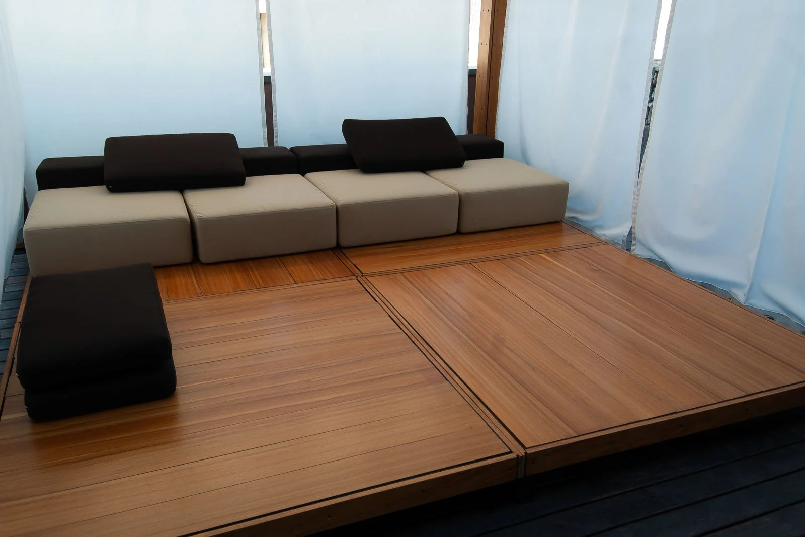 Intimate outdoor pergola with iroko kambala wood deck