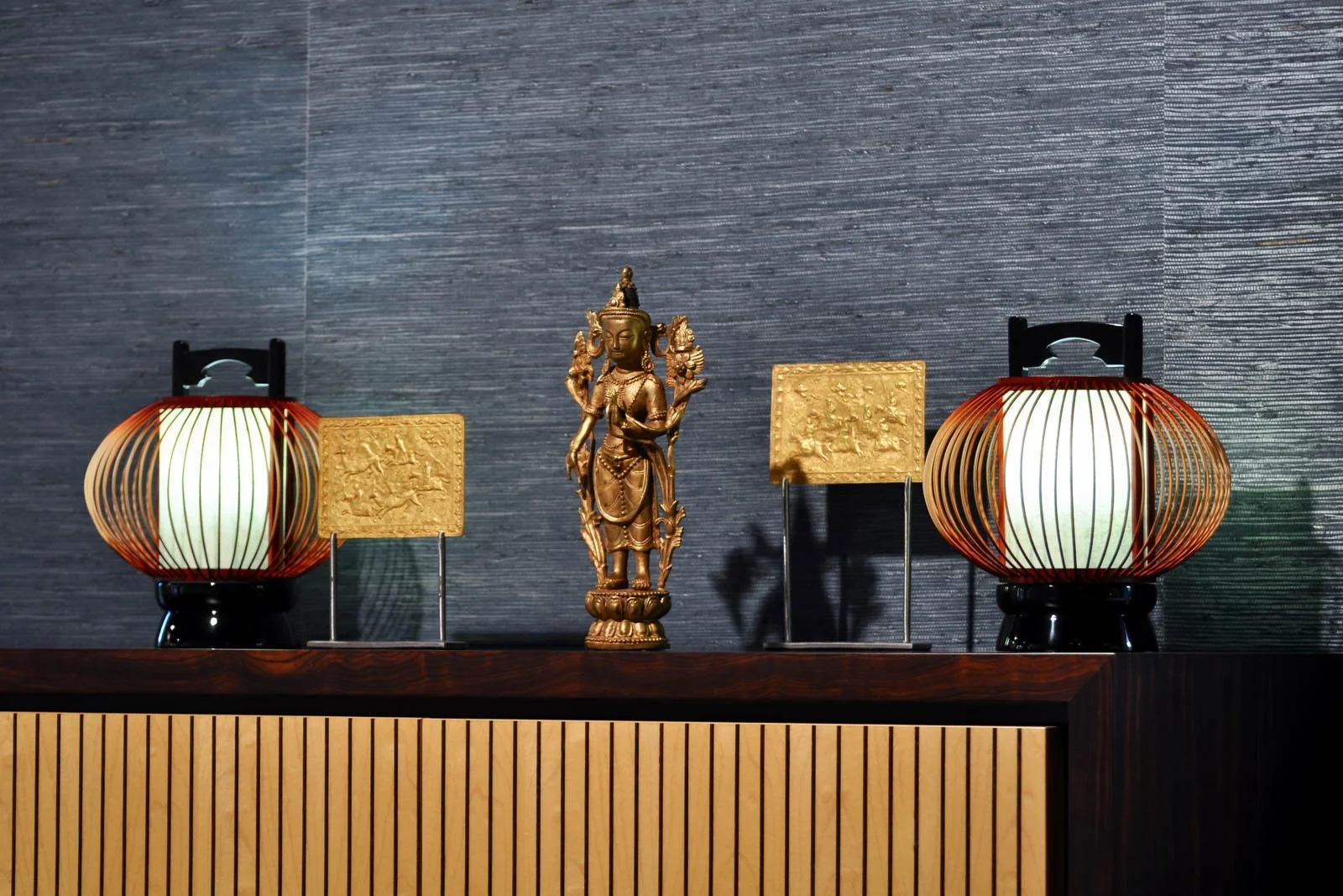 Japanese table lamps in lacquer, rattan lattice and shoji paper next to Asian art objects