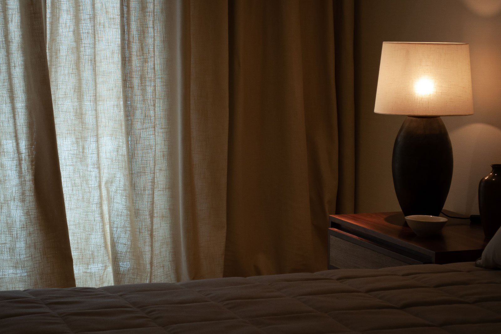 Linen voile curtains creating a warm bedroom atmosphere