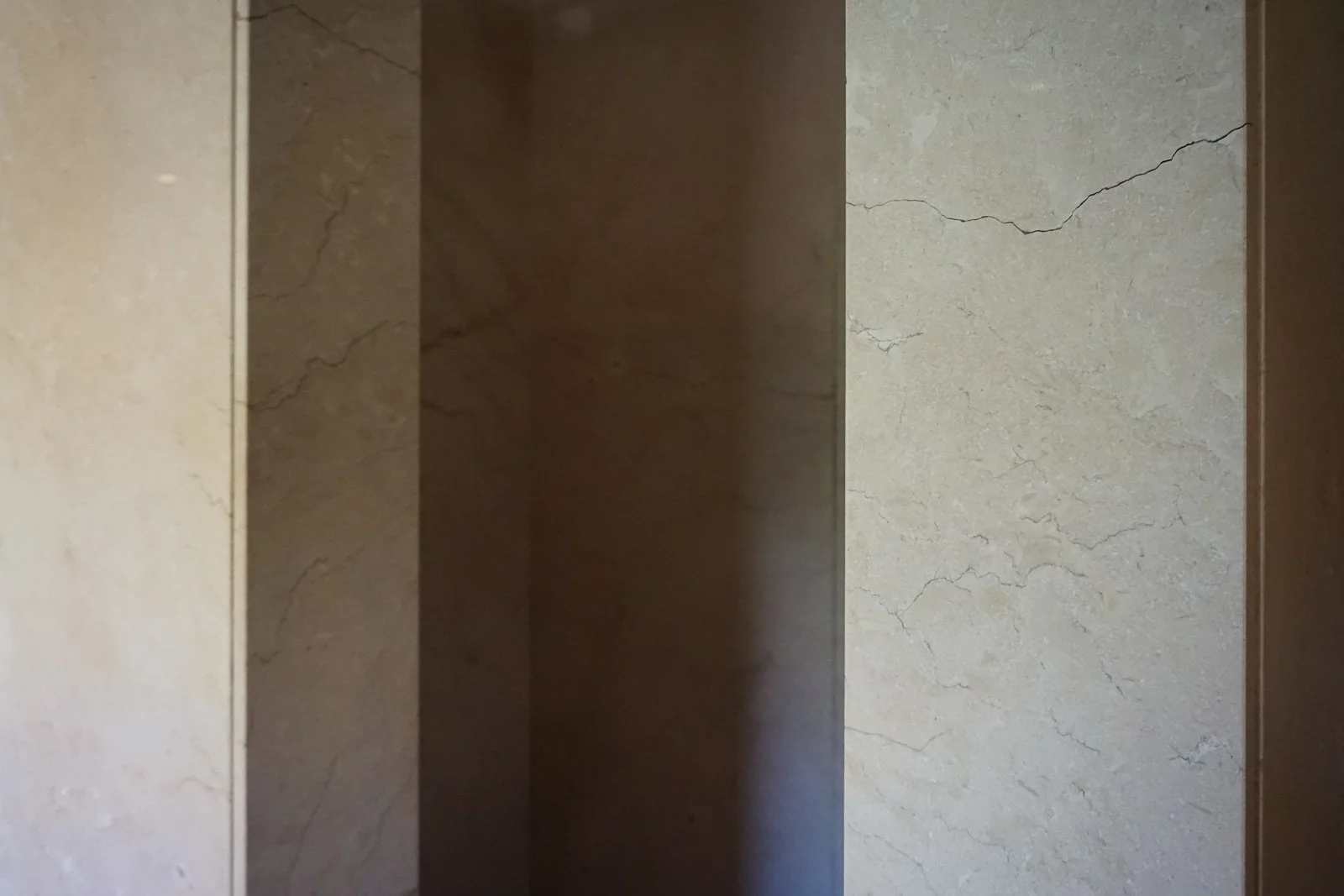Crema Marfil Spanish marble shower walls in a bathroom