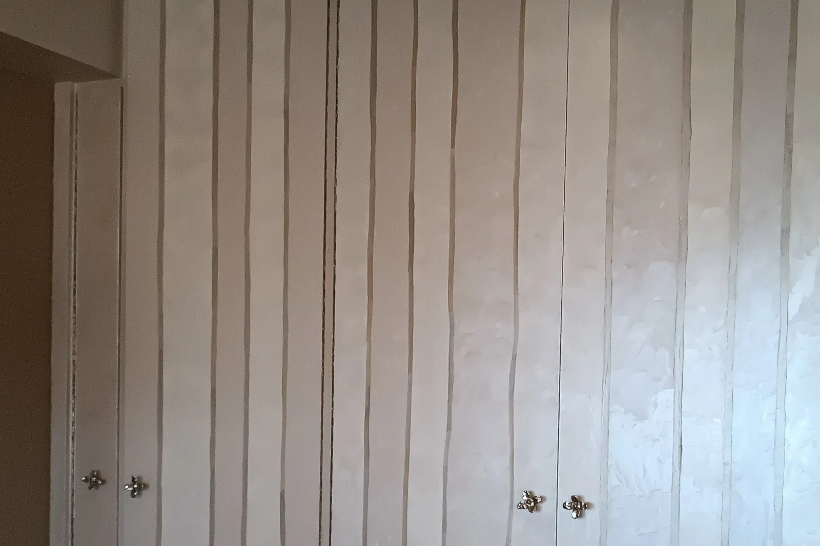 Striped metallic patina decorative painting applied to bedroom wardrobe