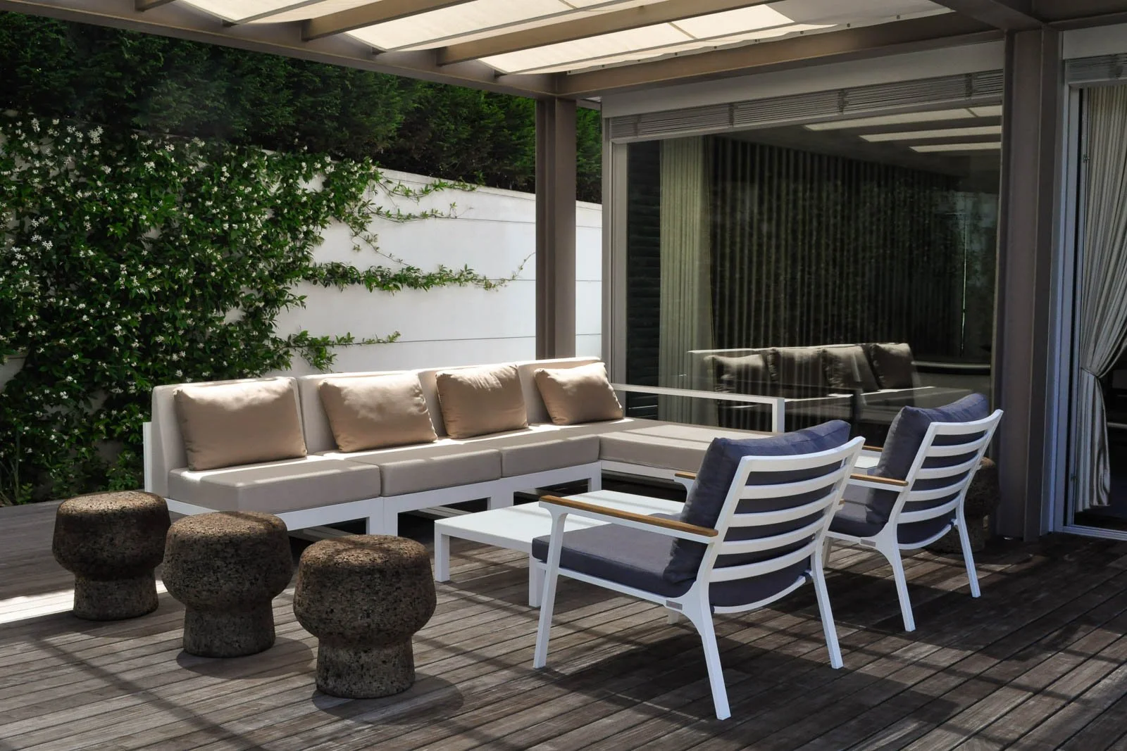 Living room side canopied deck with outdoor furniture opening to garden