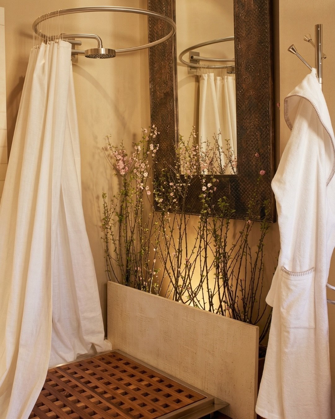 The warmth of aged brass meets the soft whisper of spring blossoms. 
We designed this sanctuary to be a full sensory experience, where the steam from the shower carries the scent of the season and every texture tells a story of craftsmanship. 
By lay