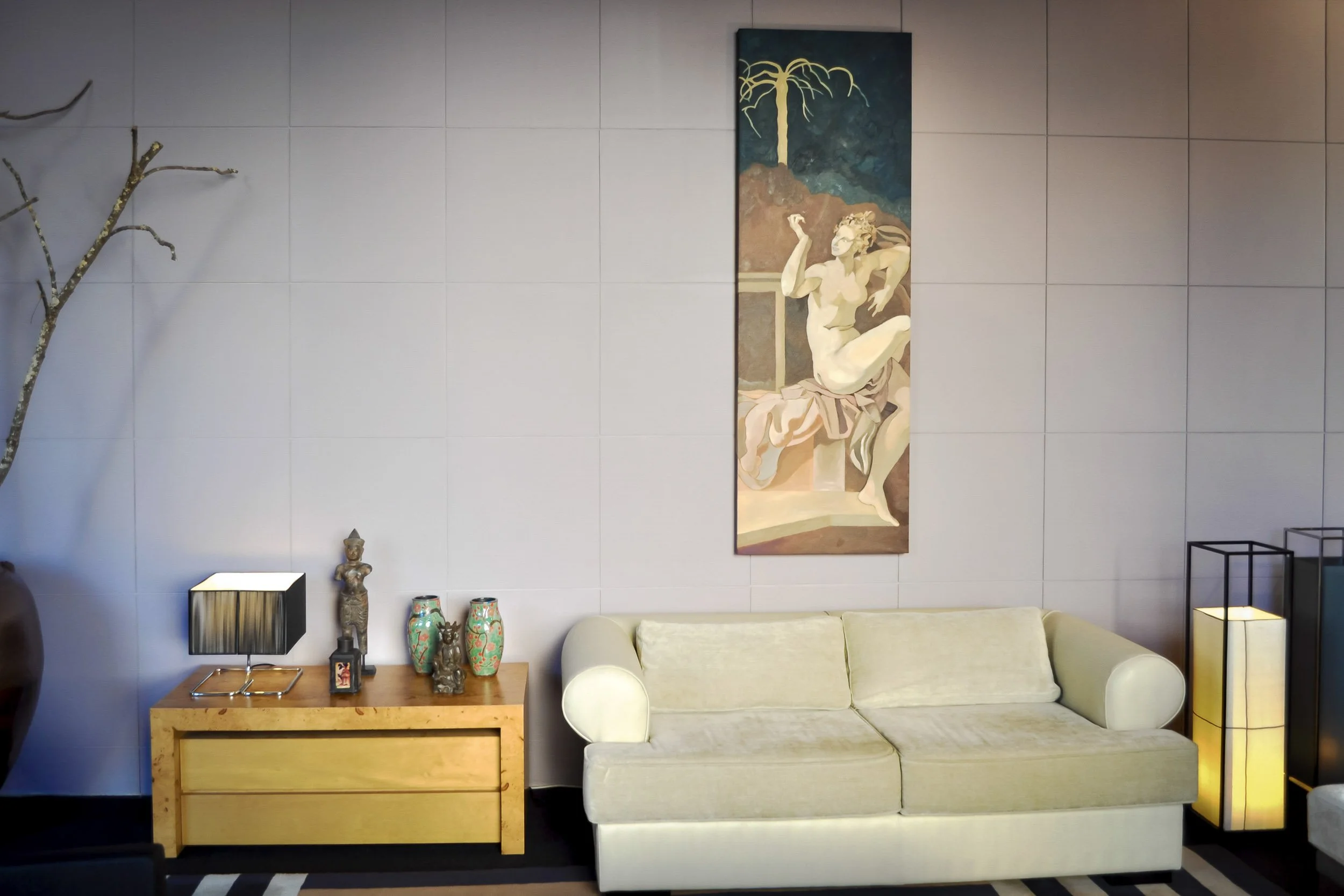 Detalhe do showroom de design de interiores de José António Andrade, no Porto, com aparador de autor que apresenta uma seleção da nossa coleção de arte asiática e uma pintura a óleo original exposta acima do sofá.