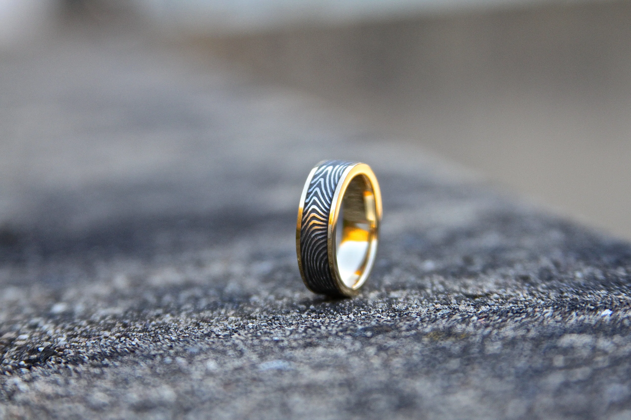 High Contrast "Hybrid" Damascus wrapped in 18kt Yellow Gold. (This ring was crafted by it's owner as part of the "MAKE YOUR OWN RING" Experience).