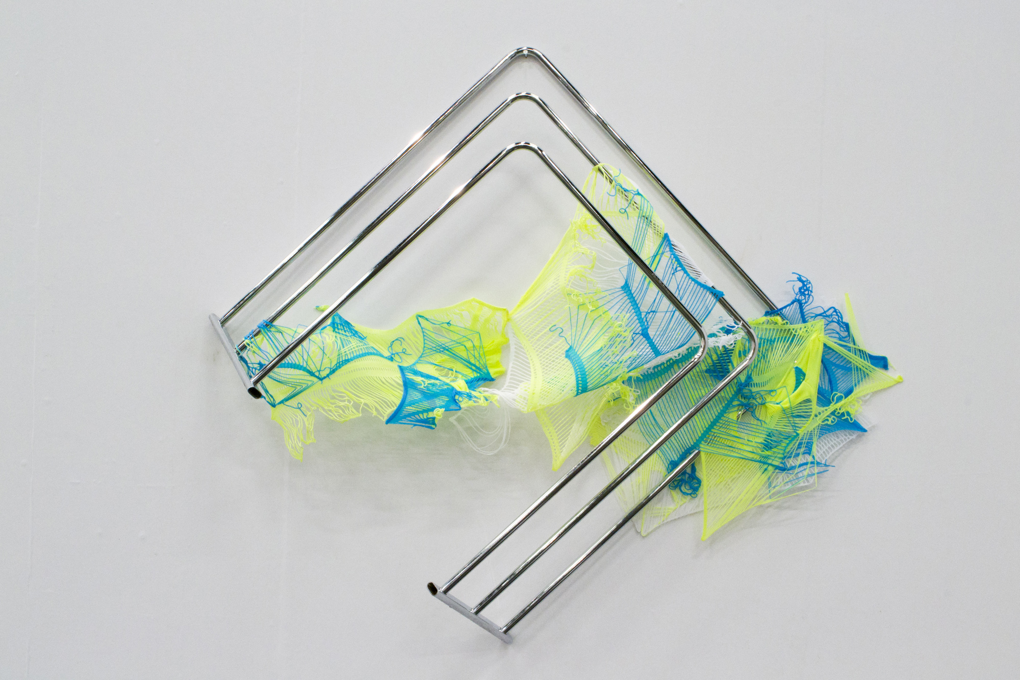 Next to skin (chartreuse azure), 2015Stretch and mesh tank tops, epoxy resin, metal towel rack.&nbsp;Exhibited at the Mélange Cologne booth at COFA Contemporary Art Fair in Cologne, November 2015
