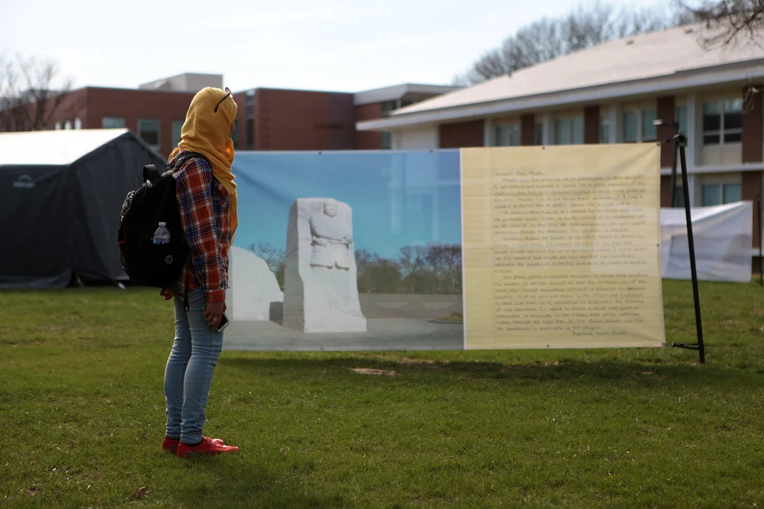 Photos requested by prisoners printed alongside their letters and displayed in George Mason University's public square.
