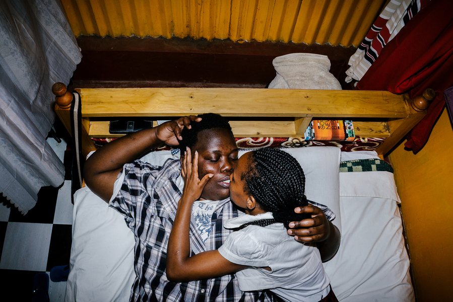 Cynthia is a lesbian activist and refugee from Burundi. She fled her country after authorities found out she was gay. They beat her and cut her with machetes. Here, she lays in bed with her Kenyan girlfriend in the apartment the two shared in Nairobi, Kenya (though they have since moved).