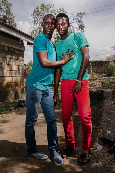   S. and J., both LGBT refugees from Uganda, pose for a portrait outside the home they lived in in a town just outside of Nairobi, Kenya.  