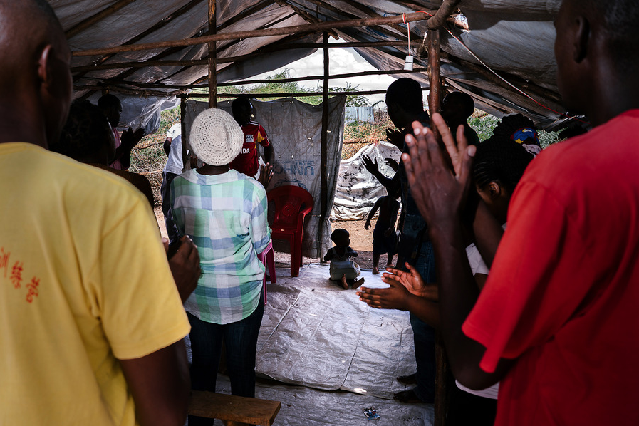   LGBT refugees attend a church service in one of their compounds. They have been kicked out of or barred from other church services in the area, but most of the LGBT refugees are deeply religious. One of the Ugandan refugees in the group was an Angl