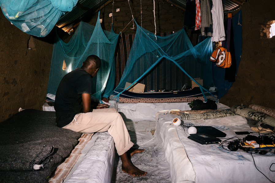   B., a gay refugee from Uganda, poses for a portrait in the mud-hut he shared with four others in the Kakuma. He fled violence and persecution in Uganda nearly a year and a half ago. He has since been resettled in the United States.  